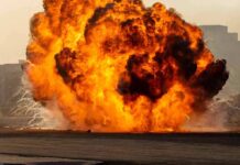 A large explosion creating a massive fireball and smoke