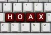 Close-up of a computer keyboard with the word HOAX spelled out in red keys