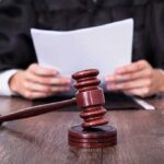 BRAZEN Legal Move Could Help Criminals A judge holding documents with a gavel in the foreground