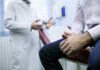 Healthcare Cover-Up — Shocking Negligence REVEALED A doctor in a white coat discussing with a patient sitting on an examination table