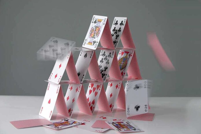 shutterstock_2130029.jpg A house of cards collapsing with some cards in motion