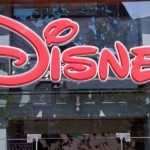 NEW Disney Death Spark Panic Over Resort Safety Bright red Disney logo displayed on a storefront window