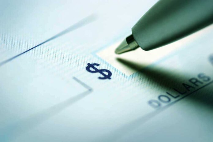 shutterstock_228062581.jpg Close-up of a pen poised over a check with a dollar sign