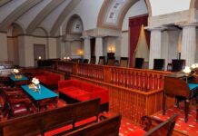 Interior of a historic courtroom featuring wooden furniture and elegant decor