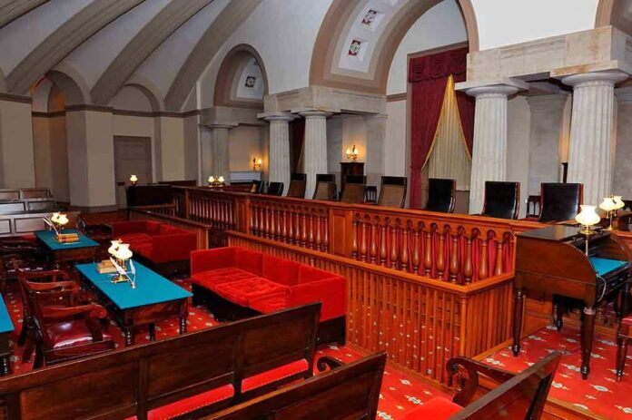 shutterstock_51424513.jpg Interior of a historic courtroom featuring wooden furniture and elegant decor