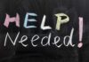 Chalkboard with the words HELP NEEDED! written in colorful chalk