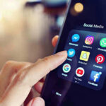 Predator Busted — Snapchats Lead to Child Trafficker Finger tapping smartphone social media app icons.