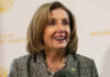 Pelosi FINALLY QUITS — It Is So ABOUT TIME! Smiling woman in plaid blazer with pearl necklace.