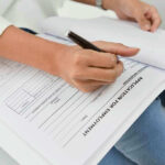 Unexpected Jobs Twist After Record Shutdown Person filling out job application form.