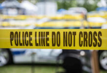 Yellow police line tape with Do Not Cross.