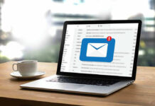 Laptop with email notification on screen at desk