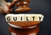 Convicted Killer Wins Big — Are They NUTS? A gavel striking down next to wooden blocks spelling 'GUILTY'