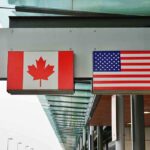 Why Canadians Are CHOOSING Death Canadian and American flags displayed at a border crossing