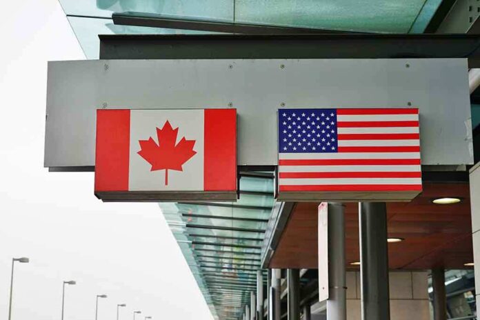 Canadian and American flags displayed at a border crossing