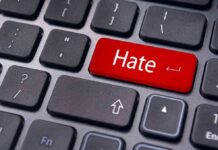 Close-up of a keyboard with a red key labeled Hate