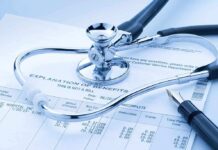 A stethoscope resting on a medical billing statement