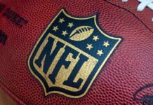 Brazen Break-In Rocks NFL Close-up of an NFL football with the logo prominently displayed