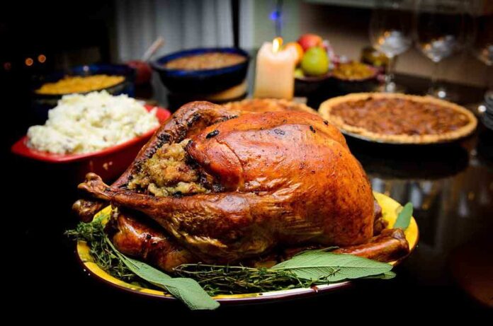 shutterstock_89799547.jpg A beautifully roasted turkey on a festive table surrounded by side dishes and decorations
