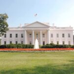 CIA-Confirmed Killer Gets White House Red Carpet The White House surrounded by manicured gardens and a fountain