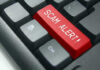 Close-up of keyboard with red SCAM ALERT key.