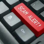 Close-up of keyboard with red SCAM ALERT key.