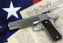 HORRENDOUS BLUNDER–Gun Rights STRIPPED Gun on U.S. Constitution and flag.