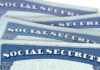 Several Social Security cards stacked together.