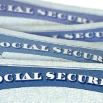 Several Social Security cards stacked together.