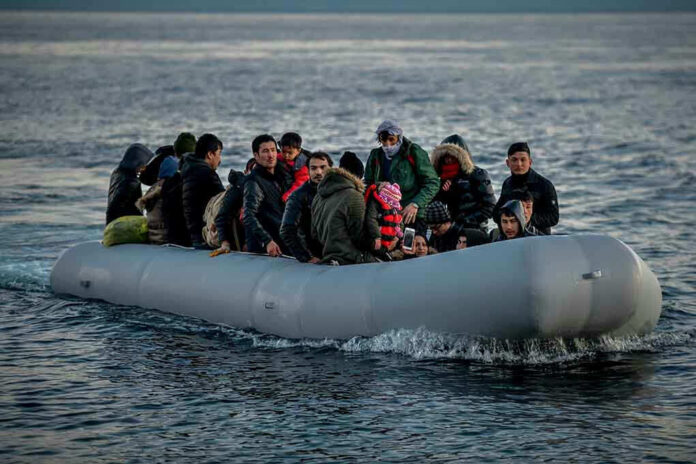 People on a packed raft in open water.