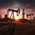 Oil Field Time Bomb: 1/2 US Crude at RISK Oil rigs operating at sunset in a desert landscape.