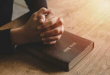 BIBLICAL Speech BANNED – Pastors Face Prosecution Hands praying on a Bible.
