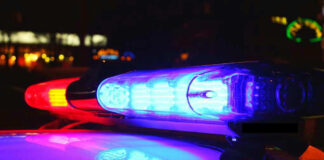 Police car lights flashing at night.