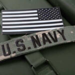 SEAL Team 6 Hero Exposes Shocking Truth U.S. Navy patch with black-and-white American flag.