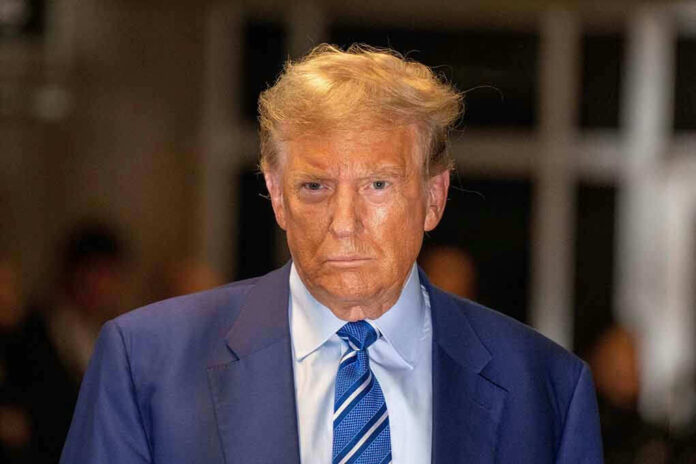 2490141757 Man in blue suit and striped tie, serious expression.