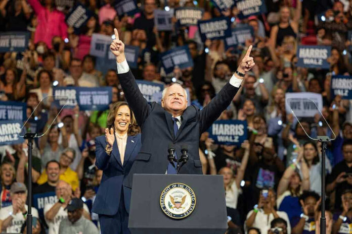 People on stage celebrating at a political rally.
