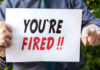 30-Year Career OBLITERATED – DESTROYED OVER SIGN Person holding YOURE FIRED sign.