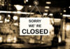 Closed sign hanging in a shop window.