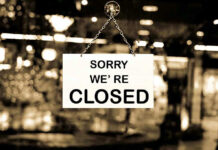 Closed sign hanging in a shop window.