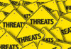 Yellow warning signs with the word THREATS.