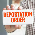 Harvard Professor’s Poor Judgment Sparks DEPORTATION Hand holding sign with Deportation Order text.