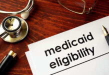 Stethoscope pen document about Medicaid eligibility on table