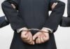 Mental Health CEO Arrested After MELTDOWN A person in a suit with hands cuffed behind their back