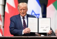 Trump’s Signs STARTLING Executive Order A man in a suit holding a signed document during a signing ceremony
