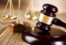 Federal Court SIDES WITH Trump on Military Policy A wooden gavel and scales of justice on a table