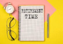 Congressional Pension GRIFT Exposed Notebook with RETIREMENT TIME written on it, accompanied by glasses and an alarm clock