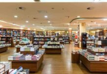 Interior view of a bookstore with shelves filled with books and wooden furniture