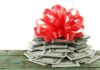 Trump’s ASTOUNDING Gift To Troops A stack of cash topped with a red ribbon bow