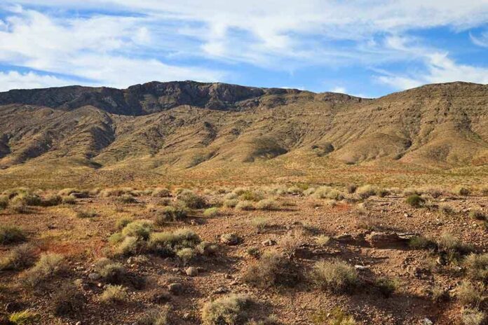 shutterstock_65997217.jpg A vast desert landscape with a mountain range under a blue sky