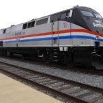 Freight Train PUSHES Car Quarter-Mile — Woman SURVIVES Amtrak locomotive parked at a railway station