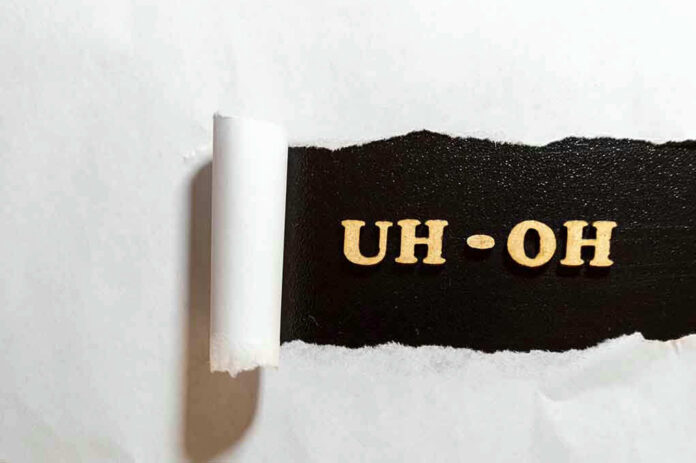 Torn paper revealing UH-OH text underneath.